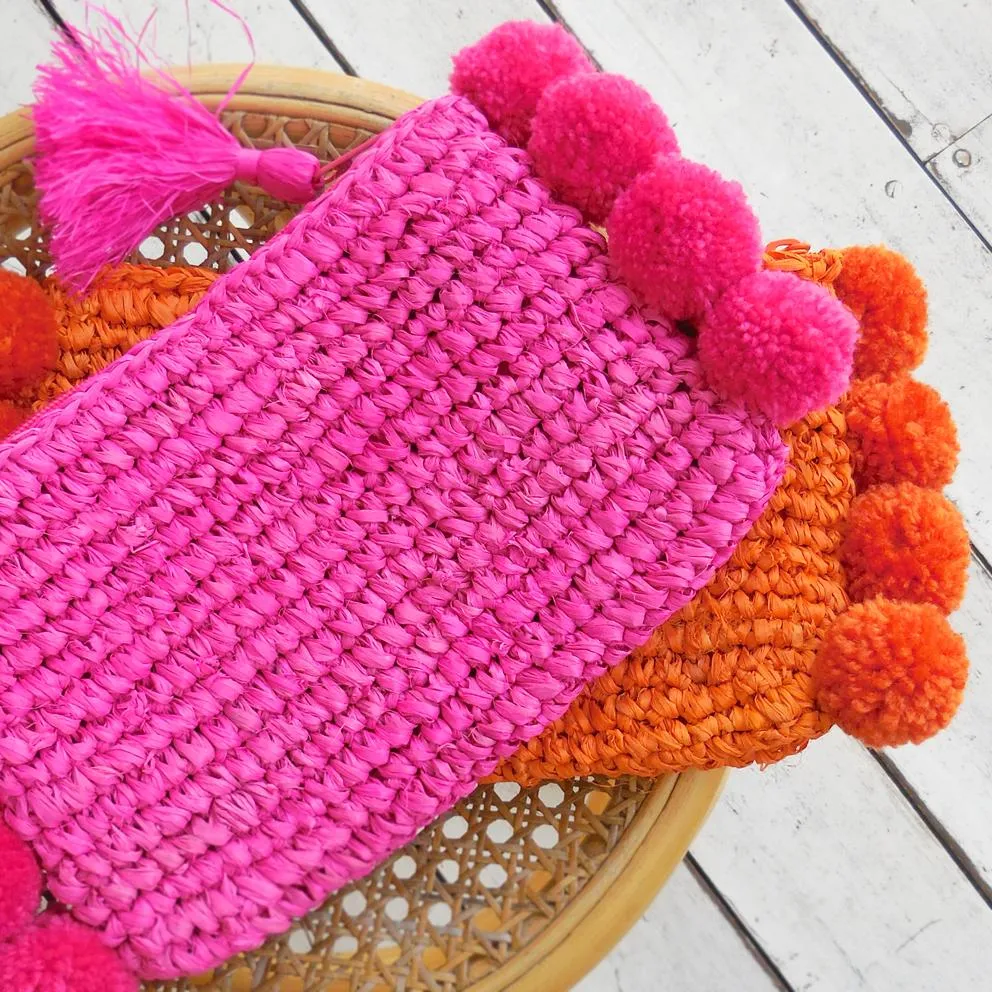 Brunna Canggu Woven Straw Clutch - in Tangerine Orange Raffia & Pom-poms